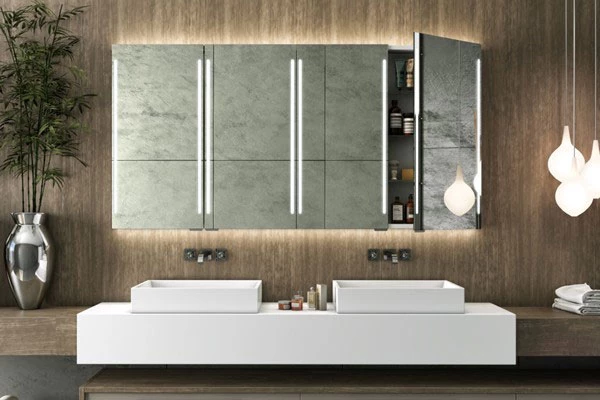 Cabinet backlit mirror with pendant lamps on the ride side and small bamboo at the left.