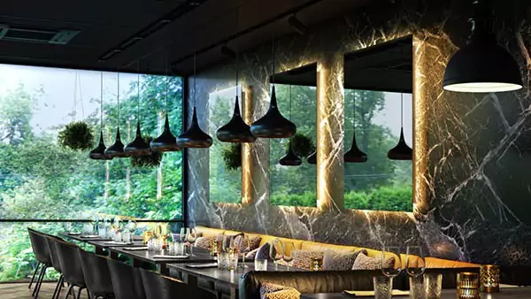 Three backlit Grand Mirrors that are mounted on the wall of a Luxurios dining table.