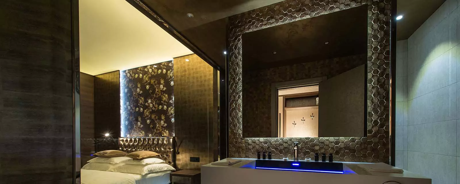 Grand Mirrors Eclipse with an elegant single sink in a dark yet sophisticated hotel room.