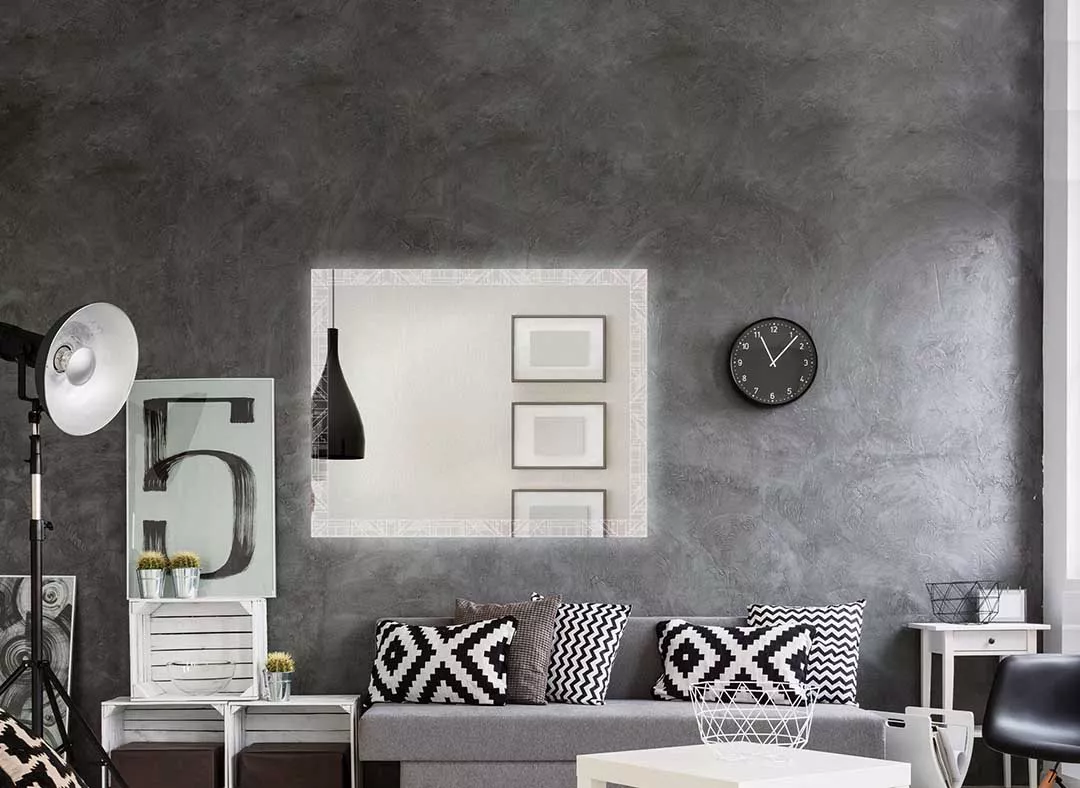 Impressive mirror with LED lights structured in a geometric pattern in a contemporary living room.